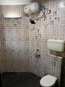 La salle de bains est pourvue de toilettes et d'un réservoir d'eau. dans l'établissement Rajlok Resort, à Pune