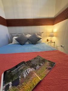 a bedroom with a bed with a magazine on it at Casa Panal , Jacuzzi opcional Villa Alemana in Villa Alemana +43 photos