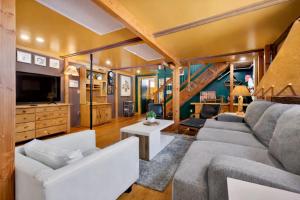 a living room with a couch and a tv at St. Vincent Lofts in Los Angeles