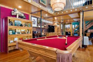 a billiard room with a red pool table at St. Vincent Lofts in Los Angeles
