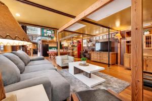 a living room with a couch and a tv at St. Vincent Lofts in Los Angeles