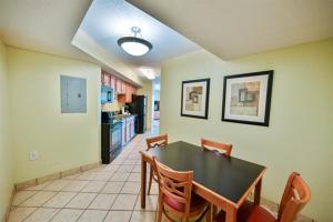 a dining room with a black table and chairs at Beachfront Condo with Stunning View Multiple Pools on BV 7th Floor in Myrtle Beach