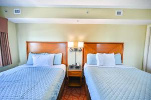 two beds in a hotel room with two at Beachfront Condo with Stunning View Multiple Pools on BV 7th Floor in Myrtle Beach +58 photos