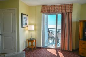 a room with a door open to a balcony at Beachfront Condo with Stunning View Multiple Pools on BV 7th Floor in Myrtle Beach