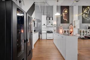 a large kitchen with white cabinets and a counter at St. Vincent Lofts in Los Angeles +51 photos