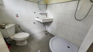 a bathroom with a toilet and a sink at Casa Srithanu in Koh Phangan