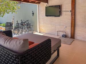 Et tv og/eller underholdning på Moreno Guest House com Piscina, churrasqueira Praia de Itaguaré e Riviera