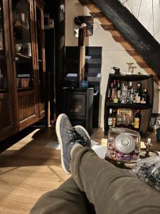 a person sitting in a living room with their feet on the floor at Cabaña Luna Rubia in La Pedrera