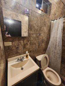 a bathroom with a sink and a toilet at Vizcaino Departamento con cocina in Ensenada