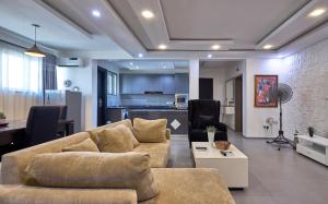a living room with a couch and a kitchen at The Haven in Lekki