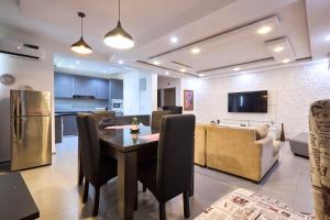 a kitchen and living room with a table and a couch at The Haven in Lekki