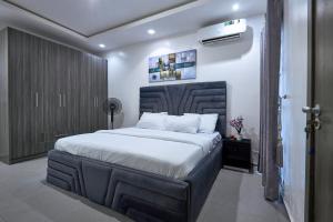 a bedroom with a large bed with white sheets at The Haven in Lekki
