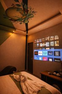 a child laying on a bed in a hotel room at Dopamine Hotel in Vung Tau