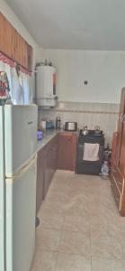 a kitchen with a white refrigerator and a stove at Duplex Playa in Santa Clara del Mar +6 photos
