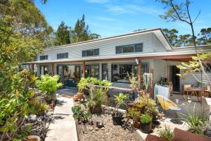 a home with a lot of plants in the yard at Hyams Reach Retreat in Erowal Bay