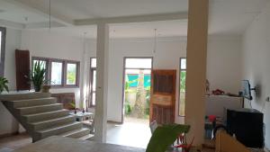 a living room with a staircase leading to a door at House 73 in Unawatuna