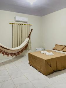 En eller flere senge i et værelse på Pousada Vale dos Buritis