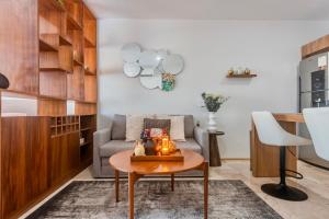 a living room with a table and a couch at Playa Azul Studio - Coco Beach I in Playa del Carmen