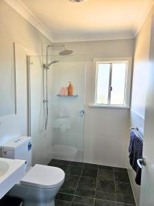 a bathroom with a shower and a toilet and a sink at Parndana Hotel Cabins in Parndana +22 photos