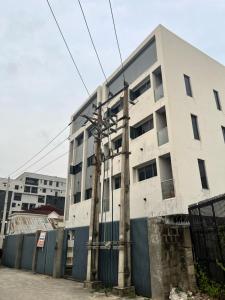 a white building with power lines in front of it at The Haven in Lekki