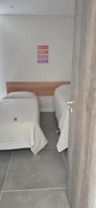 a room with two beds in a room at Kilka Departamento 3 Ambientes con Balcón in Mar de las Pampas +19 photos