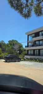 a black car parked in front of a building at Kilka Departamento 3 Ambientes con Balcón in Mar de las Pampas