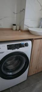 a white washing machine in a kitchen next to a counter at Kilka Departamento 3 Ambientes con Balcón in Mar de las Pampas