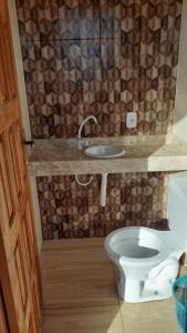 a bathroom with a toilet and a sink at Atlantic Residence - Guaxindiba in São Francisco de Itabapoana +18 photos