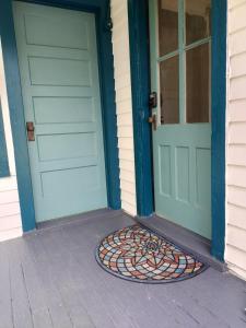 a pair of doors on a house with a mat in front at The Acorn at Oak Lodge in Palenville