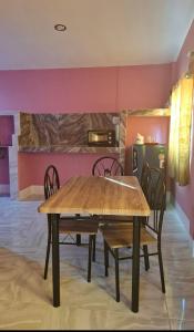 a dining room with a wooden table and chairs at Nasin House in Ko Bu Bu