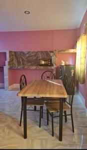 a dining room with a wooden table and chairs at Nasin House in Ko Bu Bu