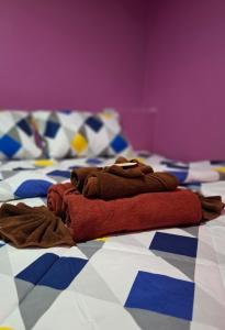 a pile of towels sitting on top of a bed at Nasin House in Ko Bu Bu