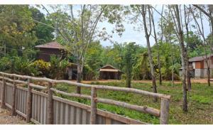 a wooden fence in front of a yard with houses at Nasin House in Ko Bu Bu +25 photos