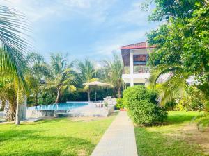 a resort with a swimming pool and a building at Ashansa Lagoon Resort in Tangalle