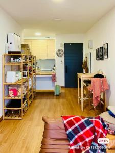 a kitchen and a living room with a couch and a table at Simple and nice unit 3 bed 2 bath in Petaling Jaya
