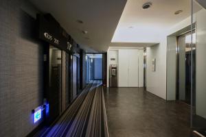 a hallway in a building with a sign on the wall at Wecan Hotel in Kaohsiung
