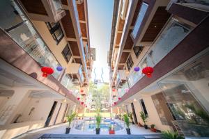 a view of a building hallway with red lanterns and plants at La Bela Casa Suites, Candolim in Candolim