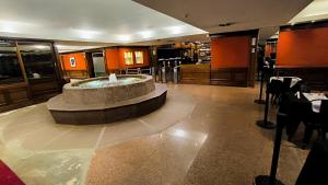 a restaurant with a fountain in the middle of a lobby at Amazing View Studio Obelisco in La Porteña