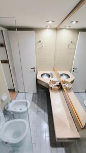 a bathroom with two sinks and a toilet in it at Amazing View Studio Obelisco in La Porteña +8 photos