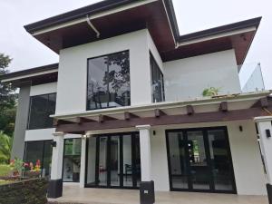 a modern house with glass doors and windows at Residential Finca Celeste in Bijagua