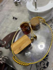a glass plate with two cups and a necklace at Rees haven in Nanyuki +13 photos