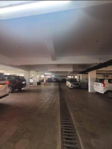a parking lot with cars parked in a parking garage at Rockmont Inn in Taliparamba