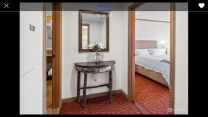 a bedroom with a bed and a table with a mirror at Suncadia Lodge in Cle Elum