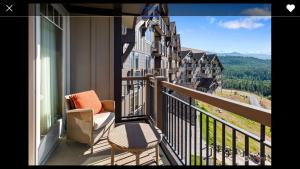 a balcony with a couch and a chair on a balcony at Suncadia Lodge in Cle Elum +10 photos