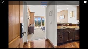 a kitchen with a door open to a living room at Suncadia Lodge in Cle Elum