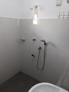 a white bathroom with a shower and a toilet at SR Home stay in Matugama +24 photos