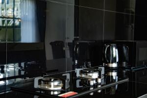 a kitchen counter with two coffee pots in front of a mirror at Phangan Cove Pool Villas in Srithanu +21 photos
