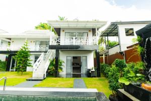 a house with a pool in front of it at Phangan Cove Pool Villas in Srithanu