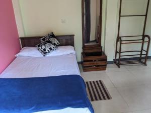 a bedroom with two beds and a mirror at SR Home stay in Matugama