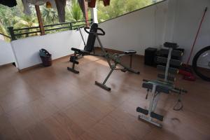 a room with a gym with a treadmill and weights at SR Home stay in Matugama